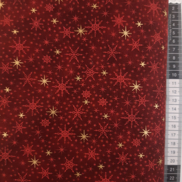 Patchwork stof jul, rød meleret med guld stjerner og iskrystaller.