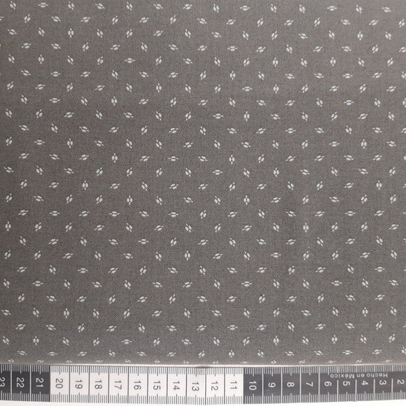 Patchwork stof, grå med små frø korn.