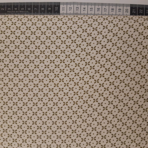 Patchwork stof, råhvid med små grønlige prikker og ovaler der danner mønster.