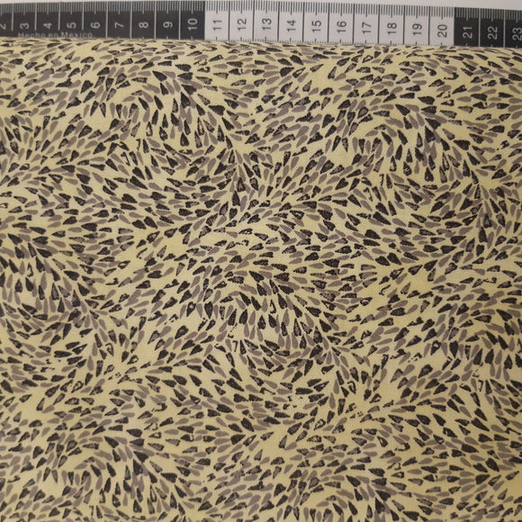 Patchwork stof, lys gul med små dråber der snurrer rundt.