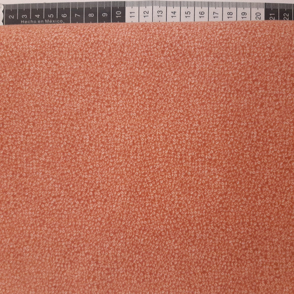 Patchwork stof, gammel rosa med små frø overalt.