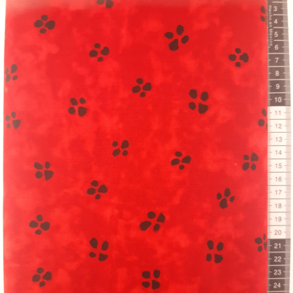 Patchwork stof, rød bund med fodaftryk fra dyr