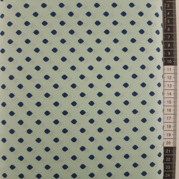 Patchwork stof, lys turkis/petroleum med mørkeblå afrundede firkanter.
