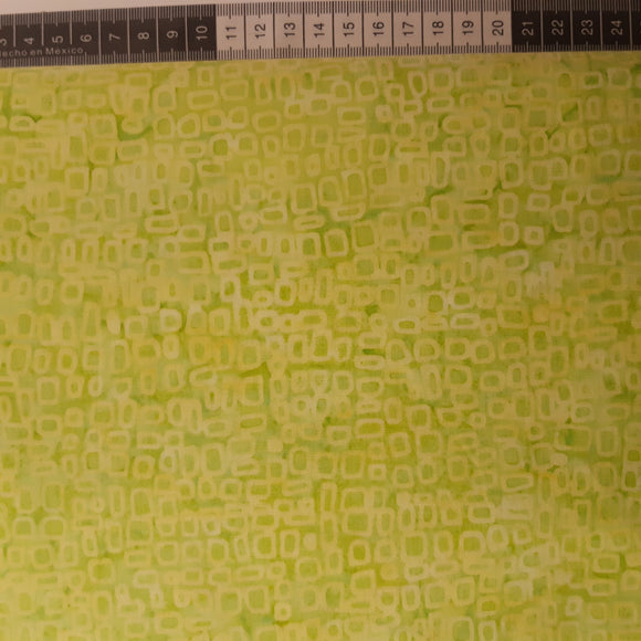 Patchwork stof, varm grøn meleret med små lysere afrundede rektangler.