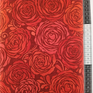 Patchwork stof, mørkerød bund med rød glimmer og store roser i forskellige røde nuancer.