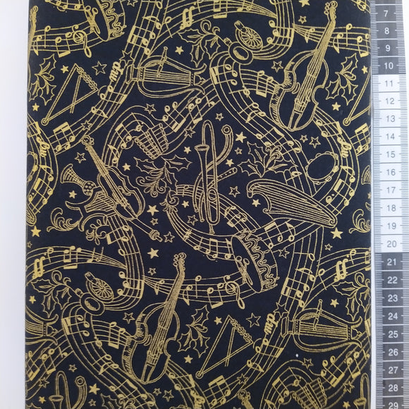 Patchwork stof, sort bund med store guld noder og musik instrumenter